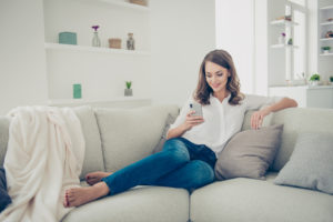 Woman with phone on couch